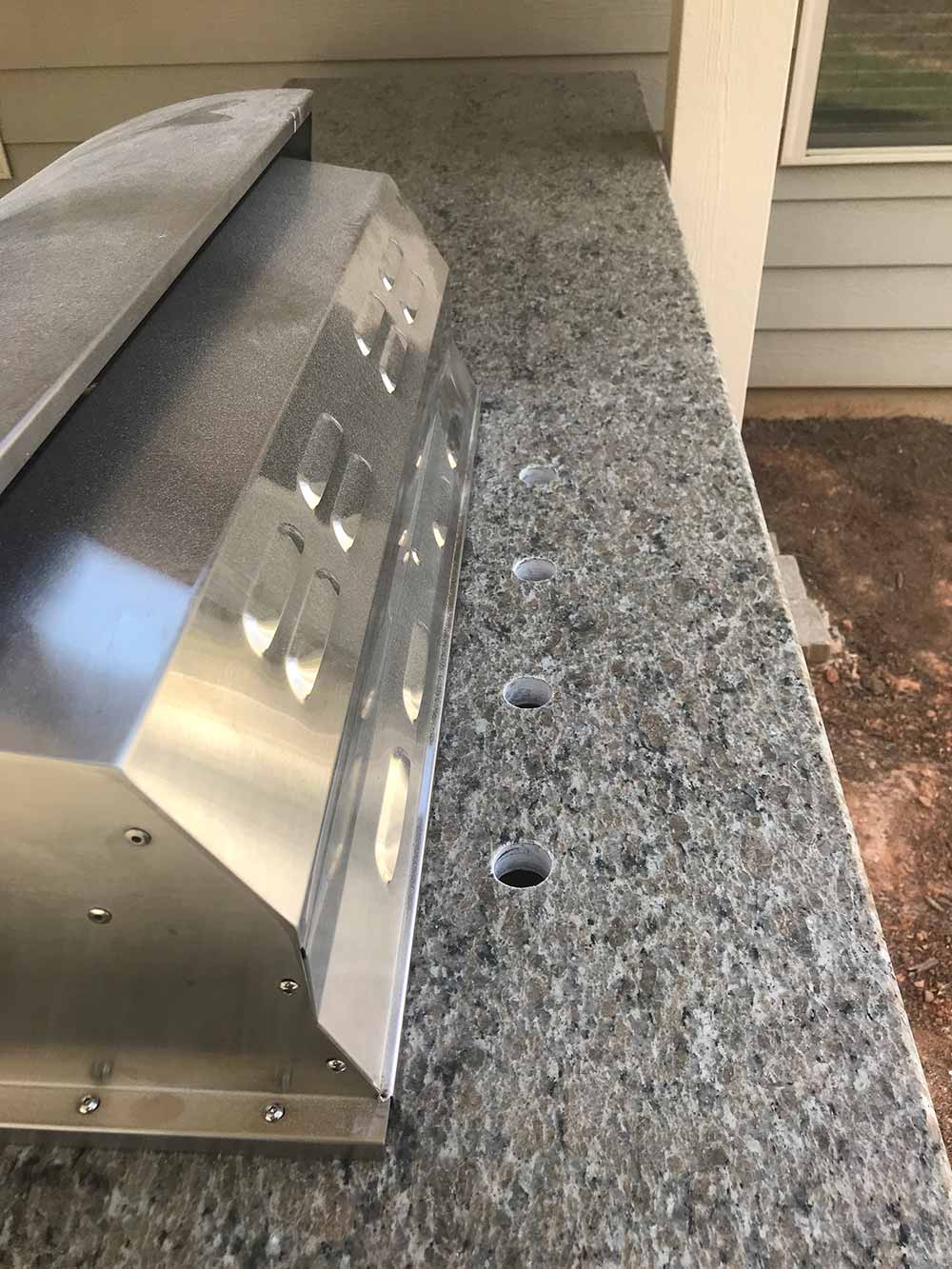 Photo of Caramalo granite installed in BBQ area.